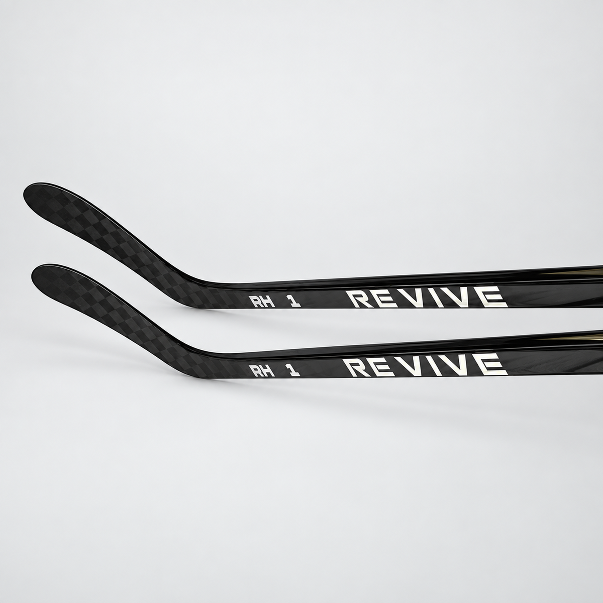 Two Revive RH1 Senior hockey sticks showing carbon construction and branding
